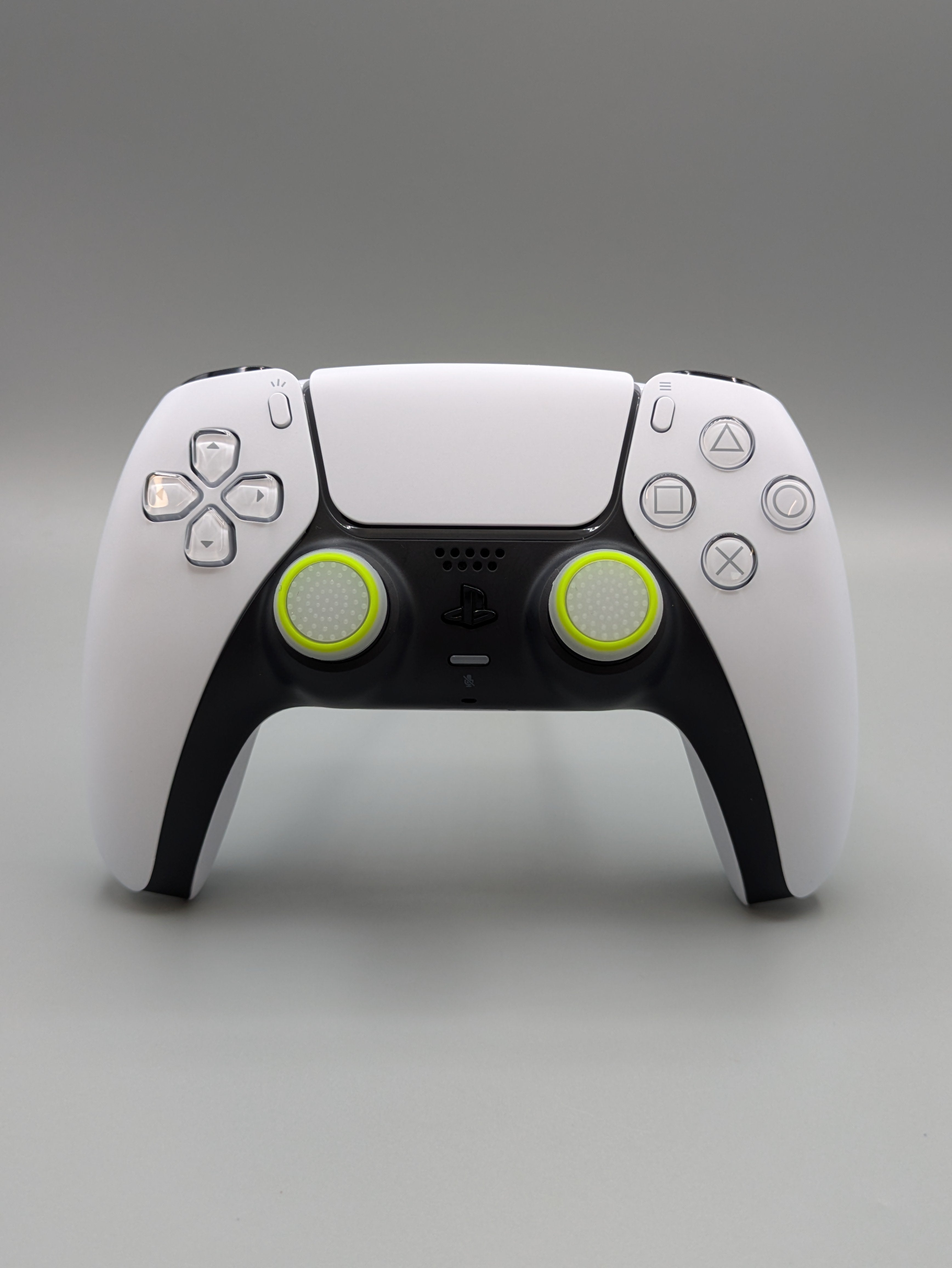 Custom PS5 controller showcasing the GOAT thumbstick toppers in white and yellow - front view